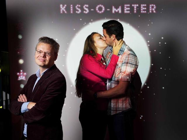 Remco Kort, author of the kissing study, stands near his Kiss-O-Meter developed for the Micropia museum (Huffington Post)